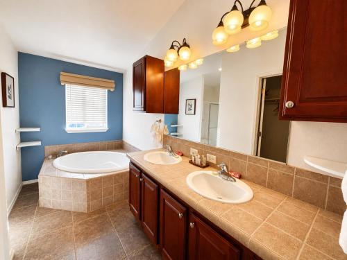 a bathroom with two sinks and a large mirror at Ticaboo Lodge in Ticaboo