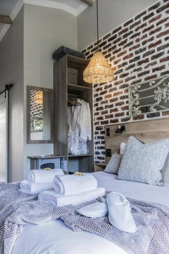 a bedroom with a bed with towels on it at Mon Cheri Clarens in Clarens
