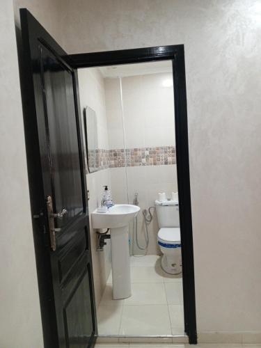 a bathroom with a sink and a toilet at Riad Bollywood Spacious 5 Beds Stay in Benguerir