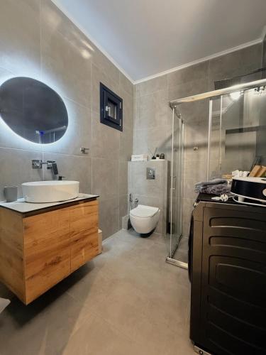 a bathroom with a sink and a shower and a toilet at Canva Living in Xanthi