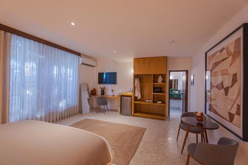 a bedroom with a bed and a living room at Abasolo Clubhouse in La Paz