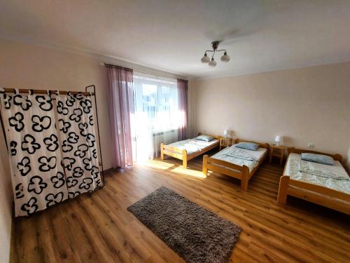 a living room with a bed and a couch at Dom u Tosi pod Zatorem in Spytkowice
