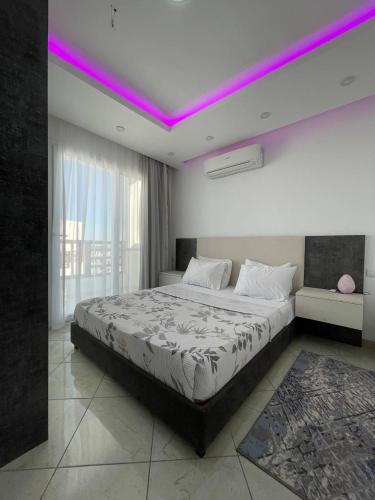 a bedroom with a large bed with purple lighting at Jasmine Resort Complex in Sharm El Sheikh