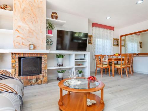 a living room with a fireplace and a table at Holiday Home Figaro by Interhome in Blanes