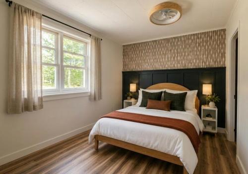 a bedroom with a large bed and a window at Lakeside Heritage Resort in Carp Lake