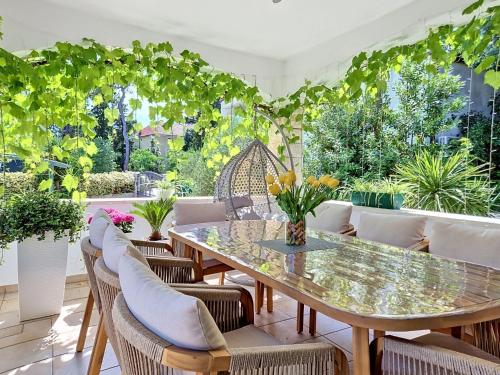 a patio with a table and chairs and plants at Holiday Home Bila Vila by Interhome in Zadar