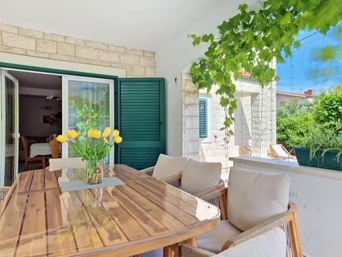 a dining room with a wooden table and chairs at Holiday Home Bila Vila by Interhome in Zadar