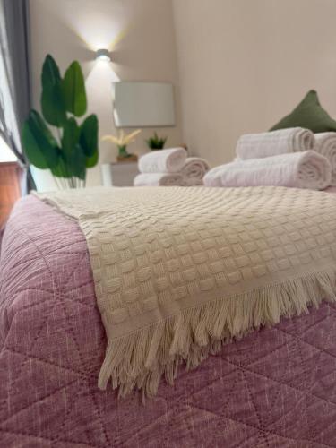 a close up of a bed with a blanket on it at Guest House Via Poerio in Catanzaro