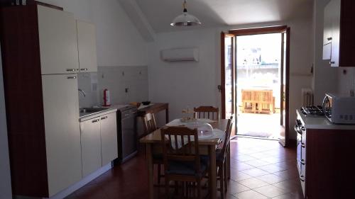 a kitchen with a table and a kitchen with a table and chairs at Terrazza in borgo San Jacopo in Florence