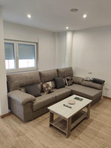 a living room with a couch and a coffee table at Luz De Luna in Negreira