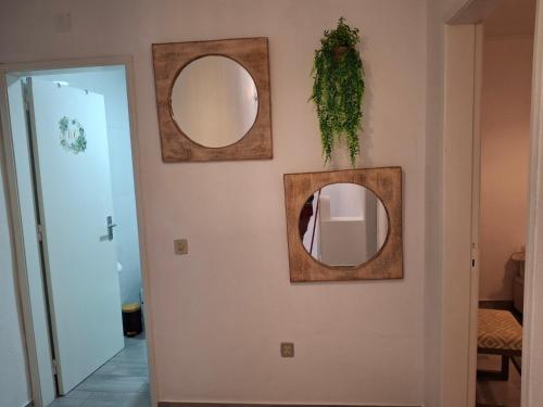 a hallway with three mirrors on a wall at Casa da Avenida in Mértola