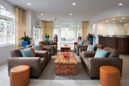 a living room with couches and a coffee table at Coconut Waikiki Hotel in Honolulu