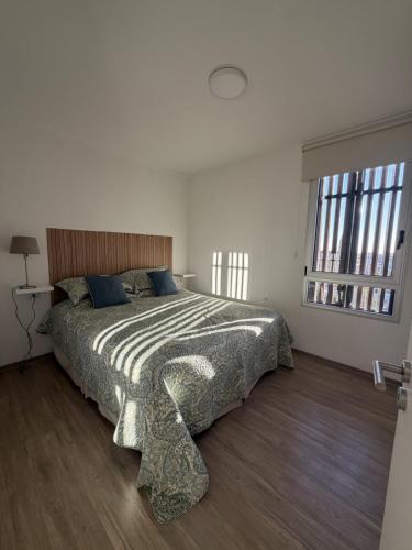 a bedroom with a large bed with a large window at Moras Urban in Esperanza