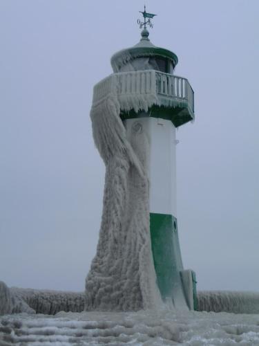 a lighthouse covered in snow with a cross on top at Fischerhaus König in Alt Sassnitz in Sassnitz