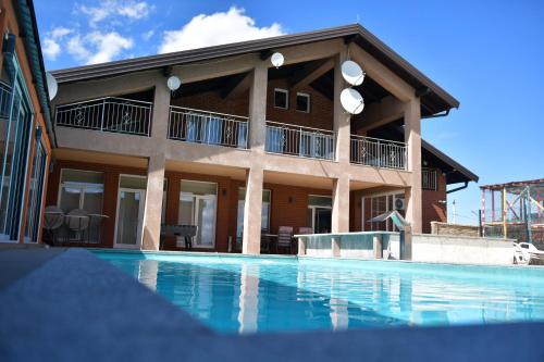 a building with a swimming pool in front of it at SIBE Apartments in Banja Luka