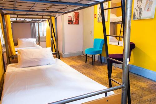 a room with two bunk beds and a chair at La Chimba Hostel in Santiago