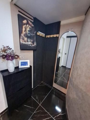 a bathroom with a mirror and a black tile floor at CasaNova in Cologne