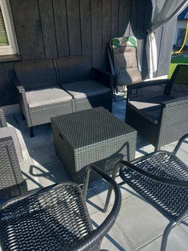 a group of chairs and tables on a patio at Domek Pod Prehybą -Agroturystyka in Gaboń