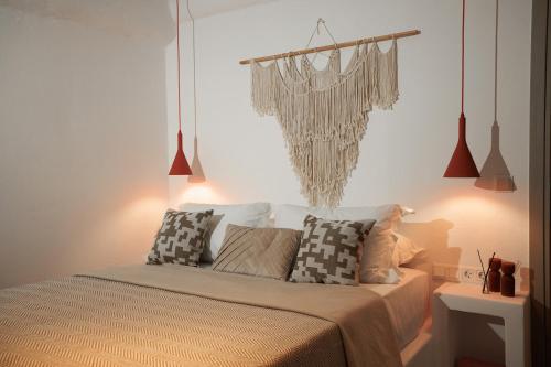 a bedroom with a bed with pillows on it at Blue Cyclades Villas in Kastraki