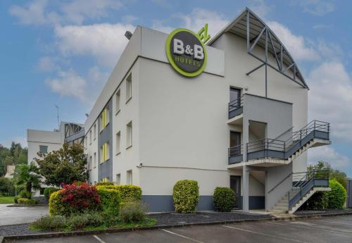 a white building with a bbq sign on it at B&B HOTEL Beauvais in Beauvais