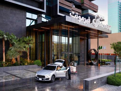 a silver car parked in front of a building at Fairmont Ramla Riyadh in Riyadh