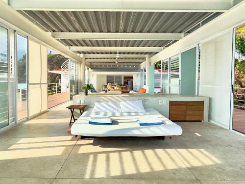 a bedroom with a large bed on a patio at Acantilado Acapulco in Acapulco