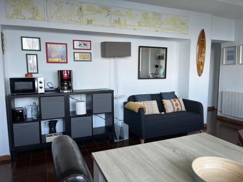 a living room with a couch and a table at Ibinaga Seaview - Auto checking property in Ibarrangelu