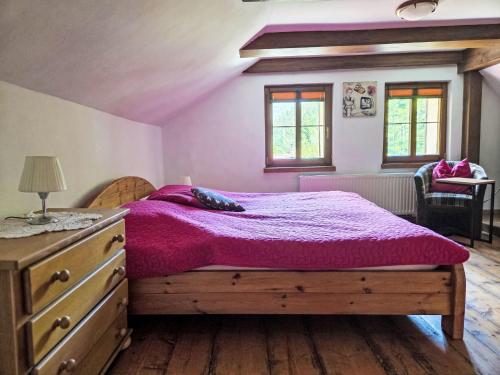 a bedroom with a bed and a dresser and windows at Holiday Home Karpacz Kowary by Interhome in Kowary