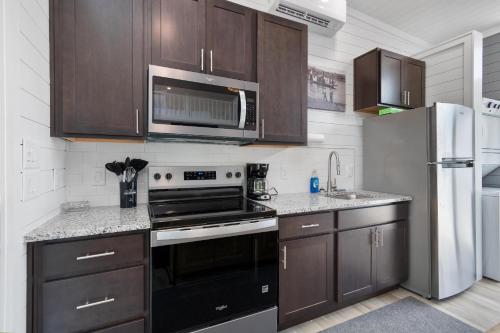a kitchen with a stove and a refrigerator at Miss Madison - Pet Friendly Floating House in Russell Springs