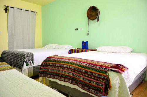 a room with two beds with blankets on them at Casa Tuta in Ciudad Vieja