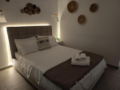 a bedroom with a bed with two towels on it at Iason studio 1 in Patitiri