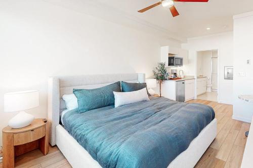 a bedroom with a large bed with a blue blanket at Mellow on Meadow Mile 2B in Fraser