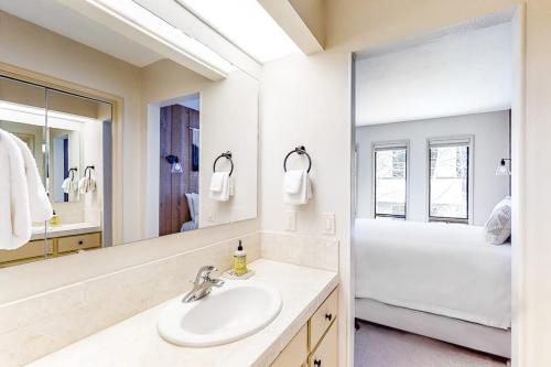 a bathroom with a sink and a large mirror at Bliss at the Base in Ketchum