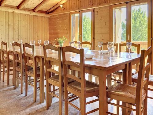 a dining room with a large wooden table and chairs at Apartment Chalet Anthamatten-2 by Interhome in Champéry