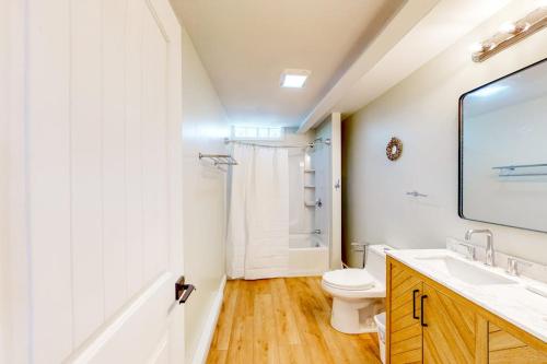 a white bathroom with a toilet and a sink at Shorelands 44-2 in Kennebunk