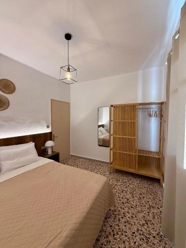 a hotel room with a bed and a tv at Mosaic House in Sami