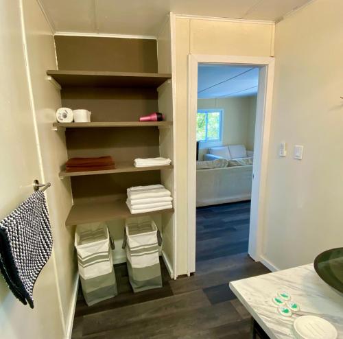 a room with a closet with towels on shelves at Cedar House Ocean View & Access in Roberts Creek