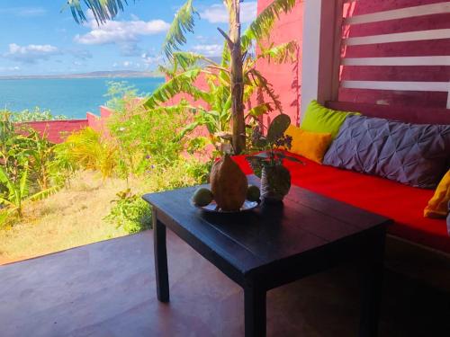 a table in a room with a view of the ocean at Maisonnette en bord de mer in Antsiranana