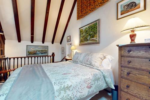 a bedroom with a bed and a wooden dresser at Great Ledges Studio in Rockport