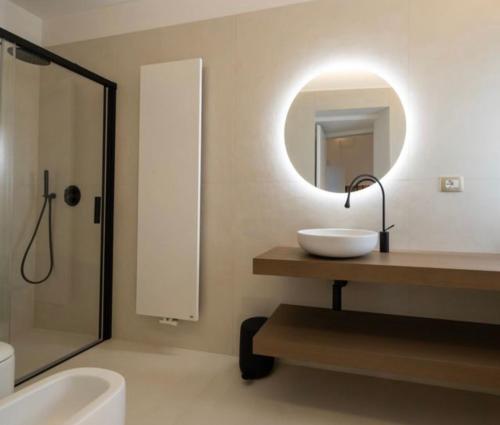 a bathroom with a sink and a mirror at Casa Novecentoundici in Castrignano deʼ Greci