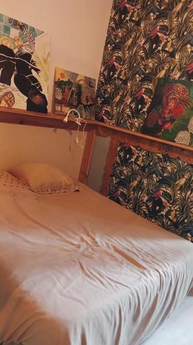 a bed in a room with a wall at Cool in Cévennes in Le Vigan