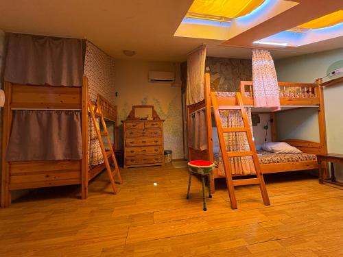 a room with three bunk beds and a room with at Just a Hostel in Sozopol