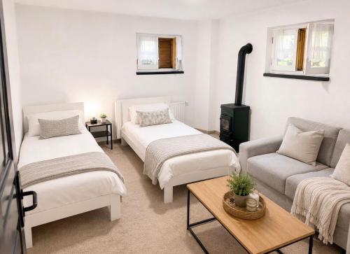 a living room with two beds and a couch at Villa Dani in Bihać
