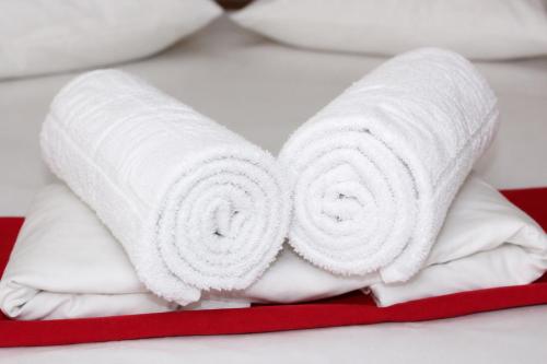 two rolls of white towels on a bed at Hotel Erisun in Vlorë