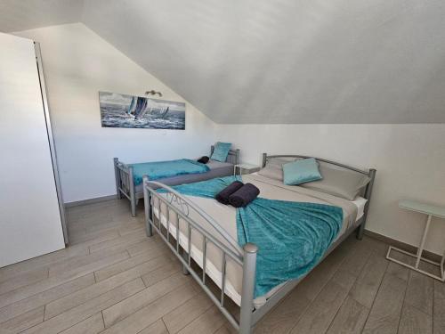 a bedroom with two beds in a room at Villa Blanka Apartments in Rogoznica
