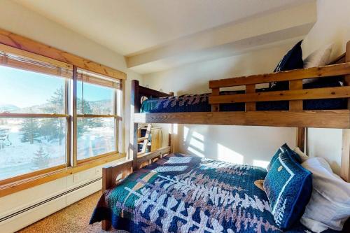 a bedroom with two bunk beds and a window at Tenderfoot Lodge 2621 in Keystone