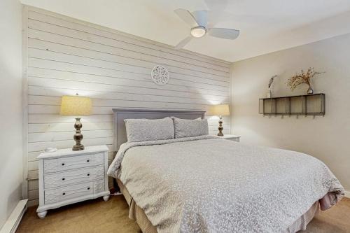 a white bedroom with a bed and a white dresser at Jarvis #301 in Durango