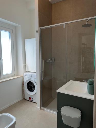 a bathroom with a shower and a washing machine at Lungomare 83 in Francavilla al Mare