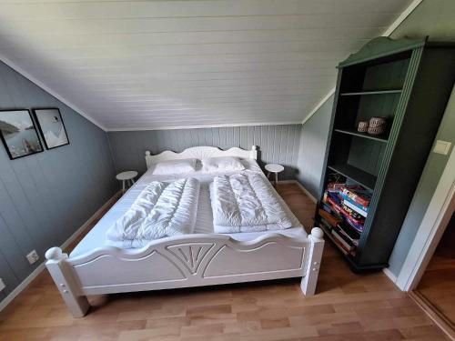 a bedroom with a white bed in a attic at Aurlandsdalen in Aurland