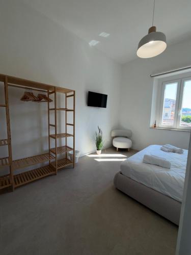 a bedroom with a bed and a television in it at Lungomare 83 in Francavilla al Mare